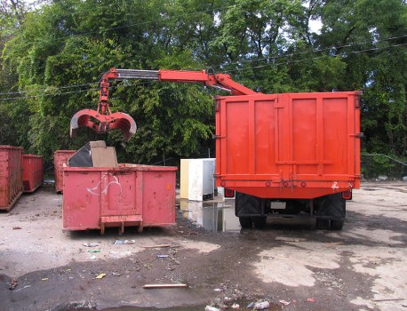 Team preparing commercial bins for curbside pickup in an Edmonton industrial area